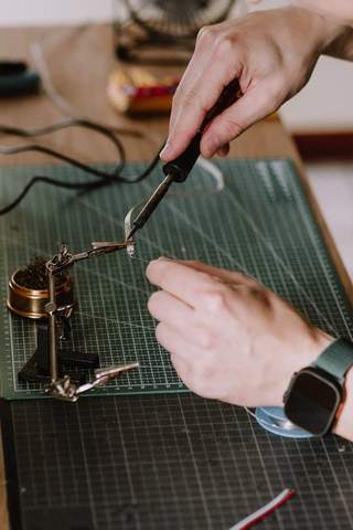 Soldering a lighting connection by hand at the workbench